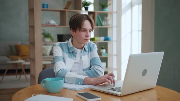 Young Student Studying on Online Learning with Video on Laptop at Home alt