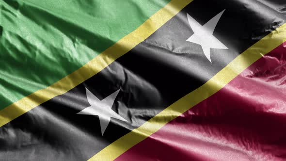 Saint Kitts and Nevis textile flag waving on the wind. Slow motion. 20 seconds loop.  alt