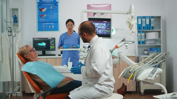 Dentistry Doctor Explaining Process of Intervention alt