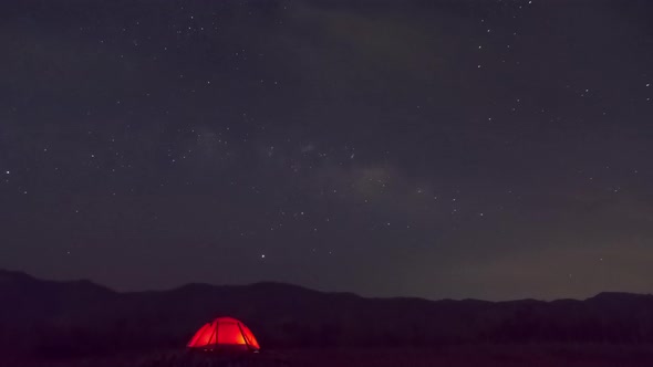 Red tent under Milky Way Galaxy Time Lapse.