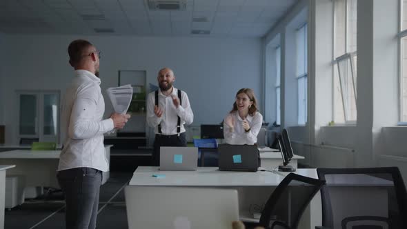 Employee Smiles Jumps and Scatter the White Paper alt