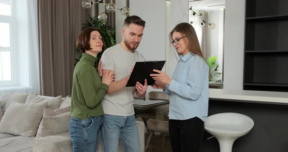 Woman Real Estate Agent Successfully Selling House to Young Family Giving Keys Reaching Agreement alt