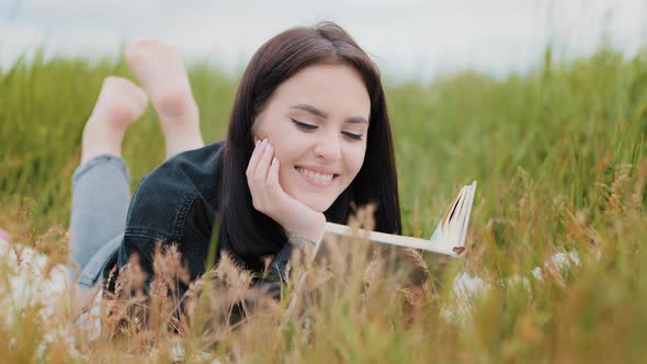 Young Serene Caucasian Brunet Woman Girl Lying on Grass Outdoors Attractive Smiling Teenage Student alt