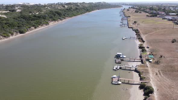 Aerial View of Drone Flying Over River with Boats Docked