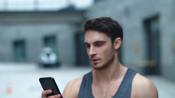 Closeup Athlete Man Looking Smartphone on Street, Smiling Man Reading Message alt