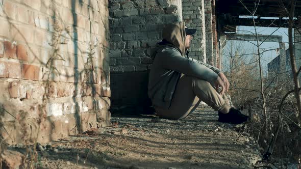 Social Problems In A Young Man. A Man In Sadness At An Abandoned Construction Site. The Man Is Sad alt