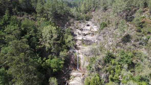 Fecha de Barjas waterfall streaming to beautiful natural pool, Peneda-Gerês National Park.