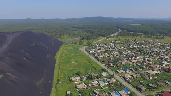 Aerial view of Huge slag dump next to residential buildings and vegetable gardens 09 alt