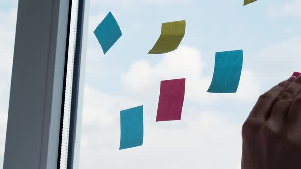 Female Project Manager Replacing Colorful Stickers Planning Working Process on Glass Wall alt