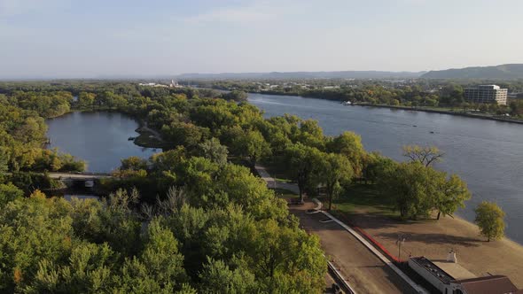 Flyover of Mississippi River in Wisconsin with beach house and beach. Lagoon area separate from park