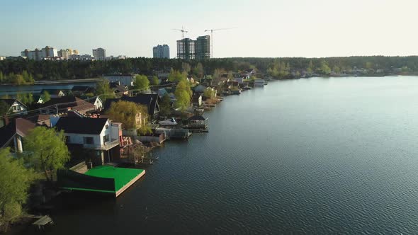 Aerial View of the Small Houses on the Lake Shore at Sunset