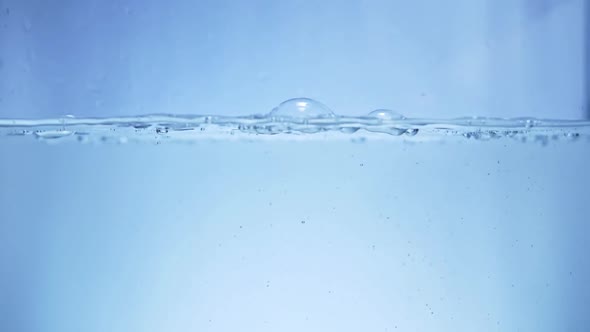 Pour Water Into the Aquarium in Slow Motion Background and Bubbles