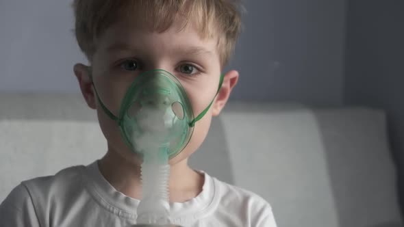 The Boy Make Inhalation Inhales the Medicine Through the Mask Nebulizer Mask