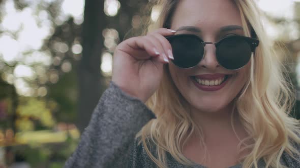 Plus Size Woman Smiling in Sunglasses