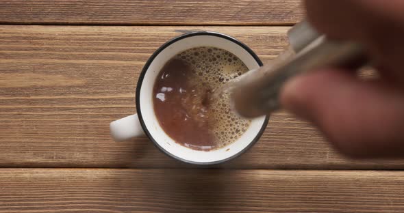 Person Adds Hot Water From a Teapot To a Cup of Instant Coffee