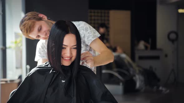Attractive Woman Smiling While Having a Consultation with Her Hair Stylist alt