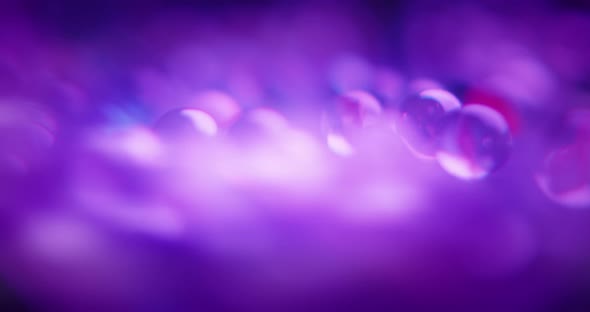 Abstract blurred shot of purple marbles alt