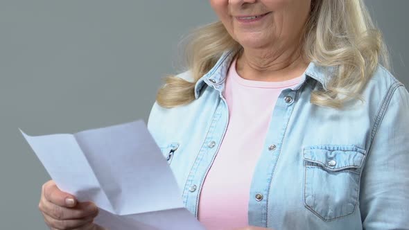 Happy Grandmother Reading Letter Holding Envelope in Hand, Correspondence, News alt