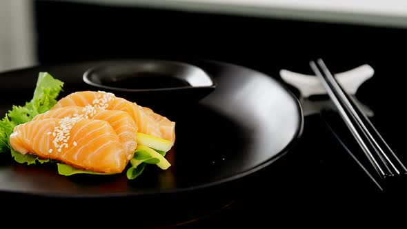 Sashimi served on plate with soy sauce alt