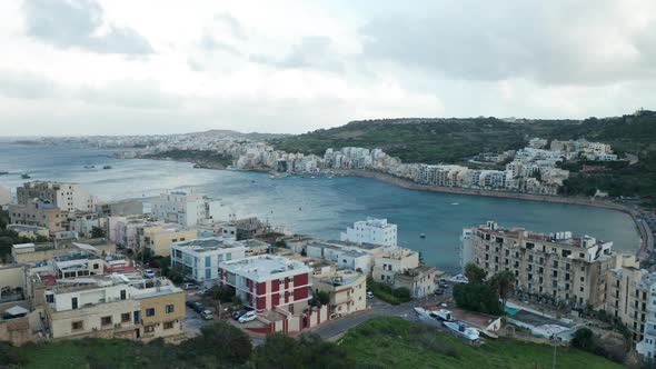 AERIAL: Very Chill Cold Evening in Mellieha Bay with Sailboats and Yachts in Winter Time in Malta alt