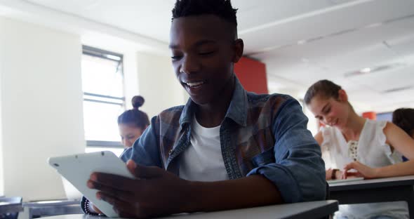 High school students using digital tablet in classroom alt