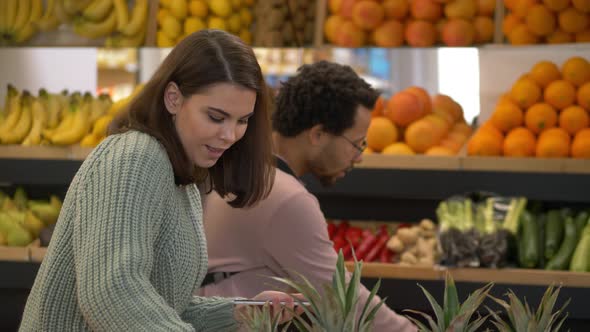 Multinational Buyers Using Grocery List in Market alt