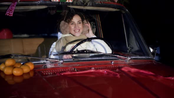 Portrait Smiling Woman in Winter Headphone Steering Wheel Inside Car alt
