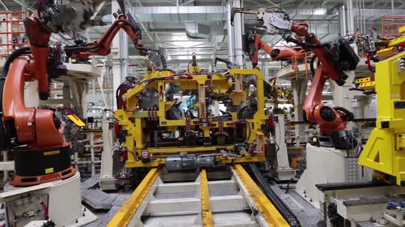 Robots Weld Parts of a New Car in a Modern Factory