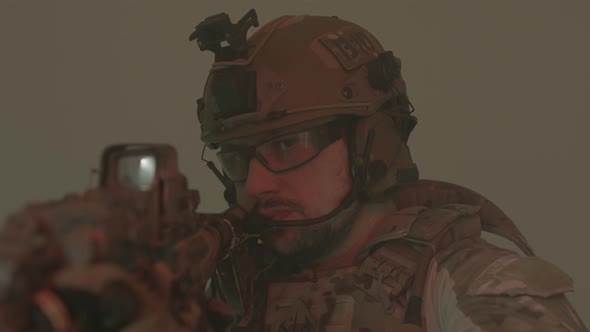 Focused Man in Protective Helmet and Uniform Taking Aim