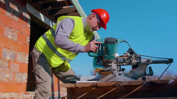 Carpenter Man Using Circular Electric Saw for Cutting Wooden Boards Woodworker at Construction Site alt