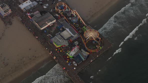 AERIAL: Circling Santa Monica Pier, Los Angeles From Above at Beautiful Sunset with Tourists alt