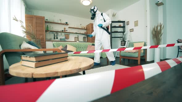 Living Room Is Getting Disinfected By a Specialist in a Hazmat Suit alt