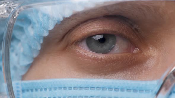 Doctor Woman Half Face, Eyes in Safety Glasses. Health Employee Looking the Camera. Portrait Medical