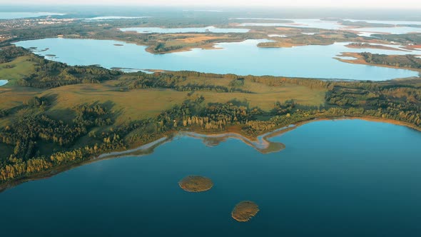 Aerial View Of Nedrava Lake And Green Forest Landscape In Sunny Summer Morning alt