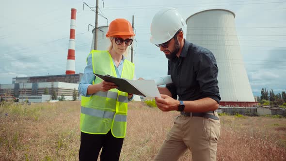 Electrical Engineer In Helmet Power Line. Constructor Checking High Voltage Sensor Power Line Wire. alt