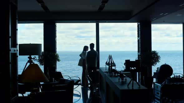 Coworkers Silhouettes Discussing Project at Panorama Ocean Window alt