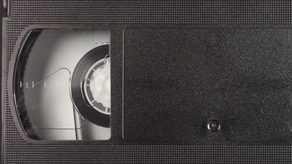 Close Up View of a VHS Tape Into a VCR Player