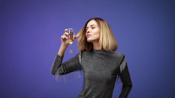 Woman in Silver Shirt Holding Glass of Champagne and Smiling