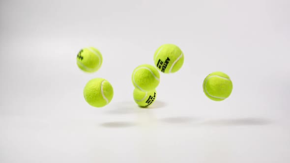 Group of Tennis Balls Falling and Bouncing in Slow Motion alt
