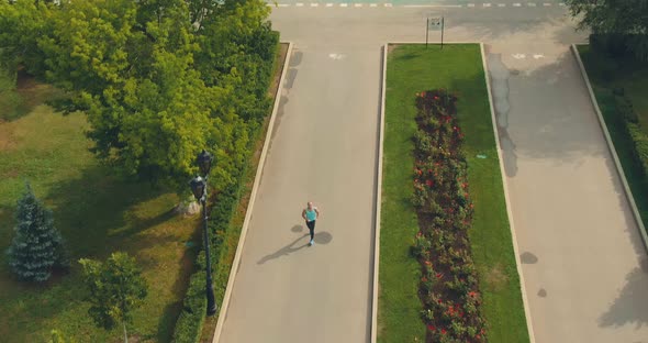 Young Man Runs Through the Park, Training. Training, Jogging. View From a Copter. Aerial View