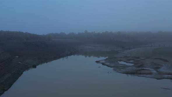 Flight Over A Dry Dam In The Autumn Foggy Day In The Late Afternoon alt