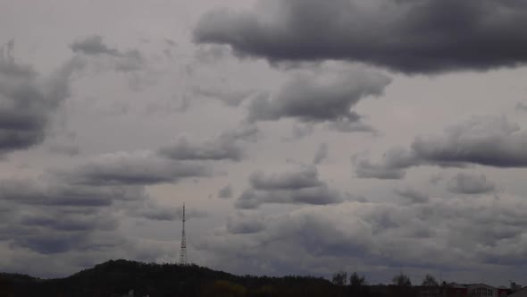 4K time lapse: television tower and beautiful fluffy clouds floating near. alt