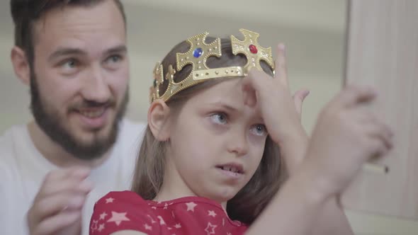 Portrait Attractive Young Bearded Father Putting the Crown on the Head of His Little Girl alt