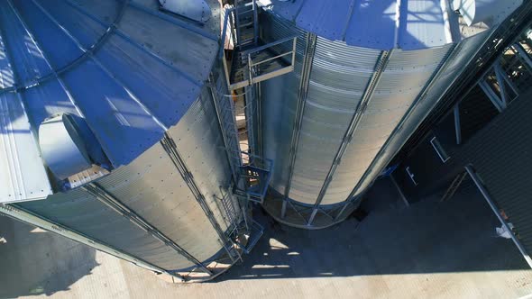 Grain Cooperative. Large aluminum containers for storing loose grain. Aerial view alt