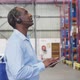 Male warehouse worker using tablet computer 4k