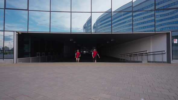 Free Running Young Peoples Doing a Somersaults on the Ground Near Modern Building Guy and a Girl alt