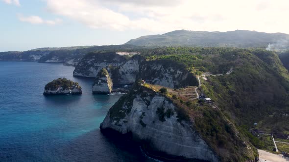 Fly Around Cliff and Rocks Over Ocean Along Coast alt