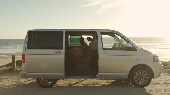 Traveling woman working on laptop in van alt