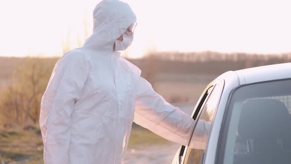 Woman in Protective Equipment Is Checking an Infant Passenger's Temperature alt