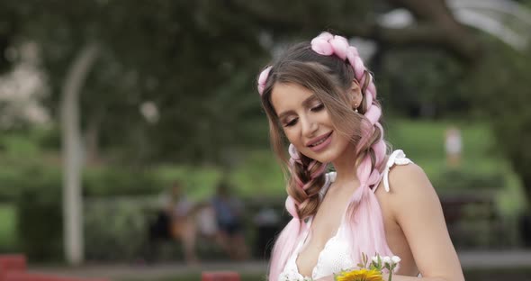 Beautiful Girl with Kanekalons Smelling the Flowers.